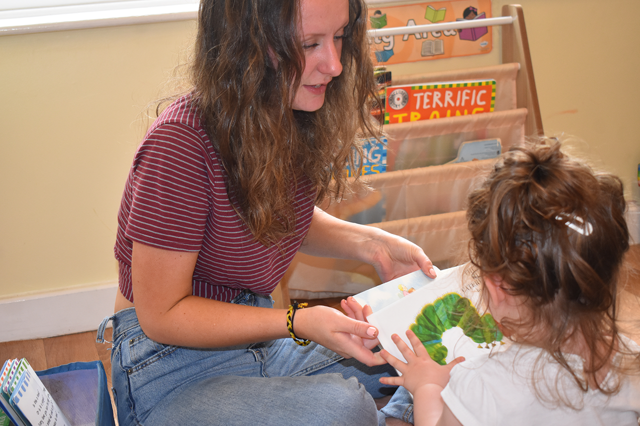One of our staff reading with a child